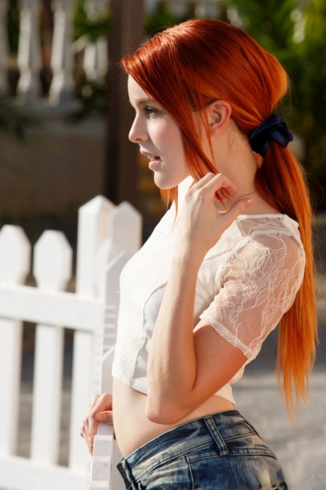 Skinny redhead lady in shorts Amarna enjoys fingering her wet beaver