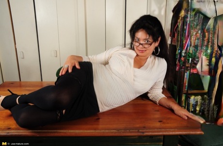 Mature Asian-American housewife exposes her big boobs and ass at home