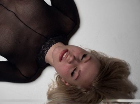 Blonde teen Lizzy B models by herself in a crotchless bodystocking