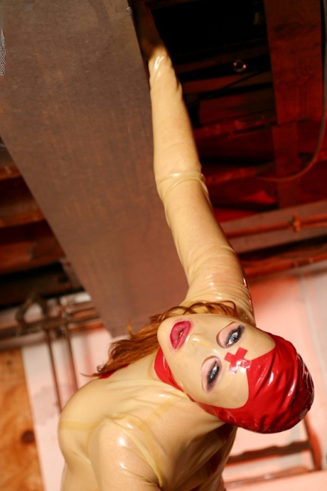 Solo model Julie Simone spreads her pussy lips in head to toe latex apparel