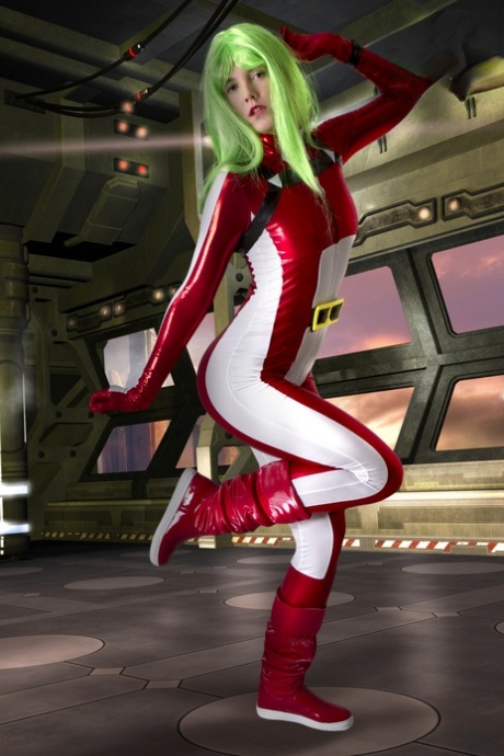 Cosplayer sports green hair while releasing her perky tits from her outfit