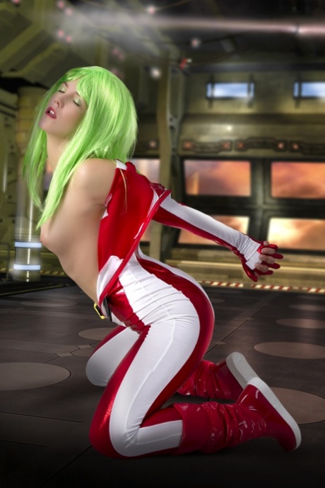 Cosplayer sports green hair while releasing her perky tits from her outfit