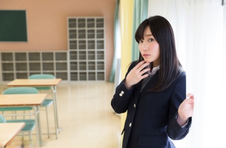 Sweet Japanese schoolgirl pulls down panties showing bare ass in the library