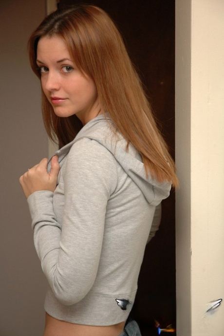 Amateur model with a pretty face poses non nude in denim jeans