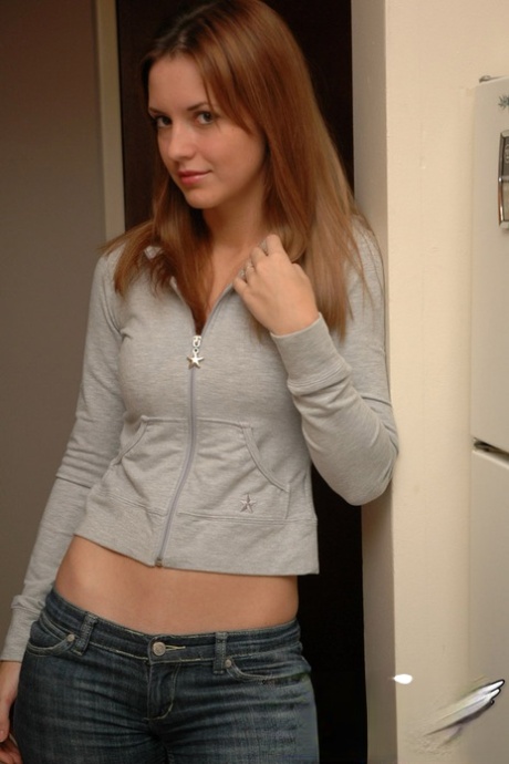 Amateur model with a pretty face poses non nude in denim jeans
