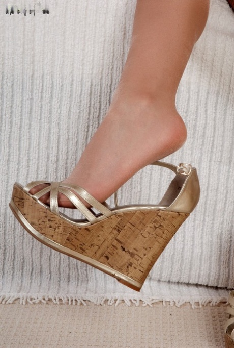 Brunette solo girl releases her sexy feet from platform shoes and hose
