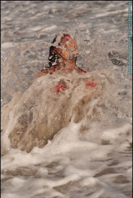 Solo model Brenna Sims poses in a micro bikini while at the ocean
