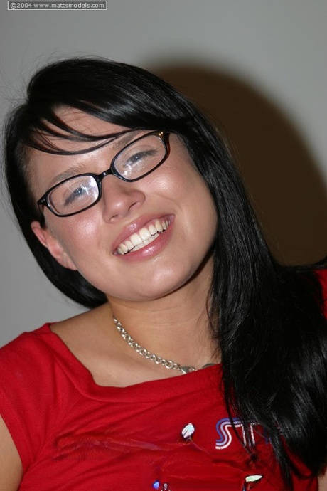 Geeky girl Eva parts her pink pussy while totally naked in glasses