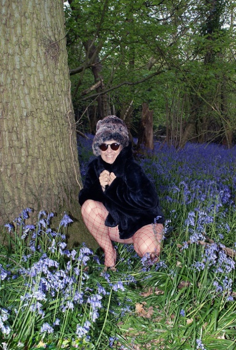 Mature lady removes her winter coat to show her big naturals in mesh pantyhose