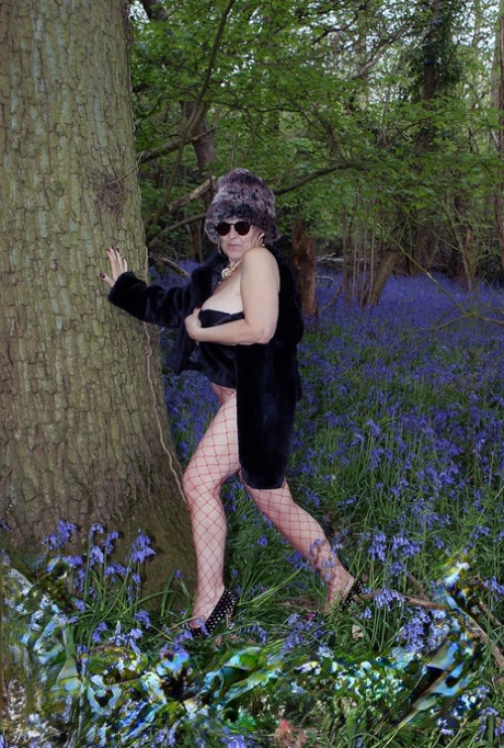 Mature lady removes her winter coat to show her big naturals in mesh pantyhose