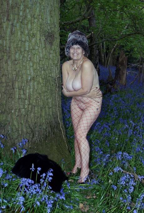Mature lady removes her winter coat to show her big naturals in mesh pantyhose
