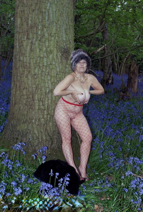 Mature lady removes her winter coat to show her big naturals in mesh pantyhose