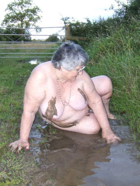 Fat nan Grandma Libby steps into a puddle before covering herself in mud