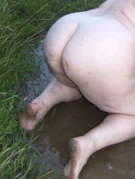 Fat nan Grandma Libby steps into a puddle before covering herself in mud
