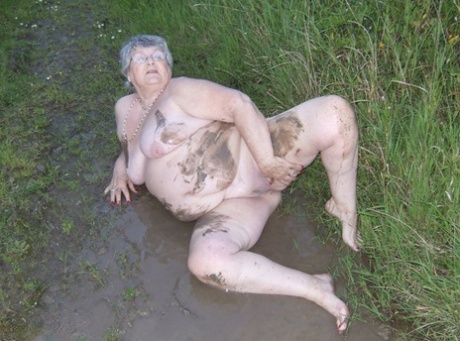 Fat nan Grandma Libby steps into a puddle before covering herself in mud