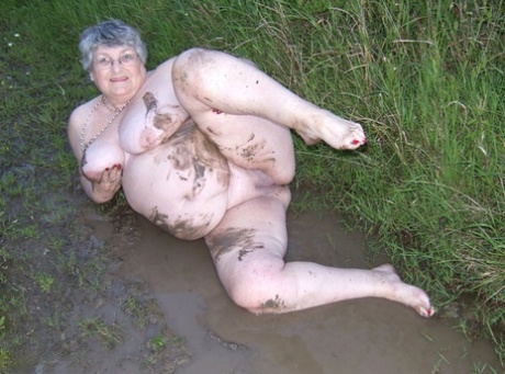 Fat nan Grandma Libby steps into a puddle before covering herself in mud