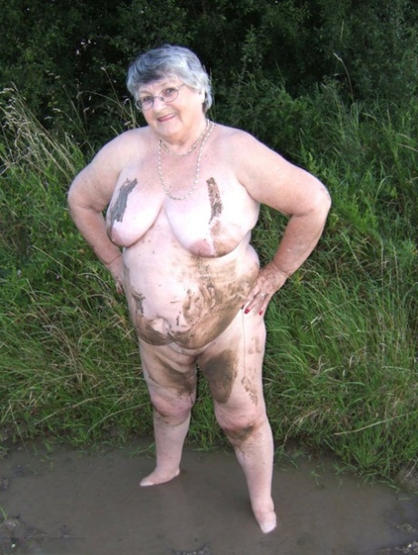 Fat nan Grandma Libby steps into a puddle before covering herself in mud