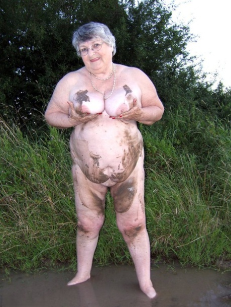 Fat nan Grandma Libby steps into a puddle before covering herself in mud