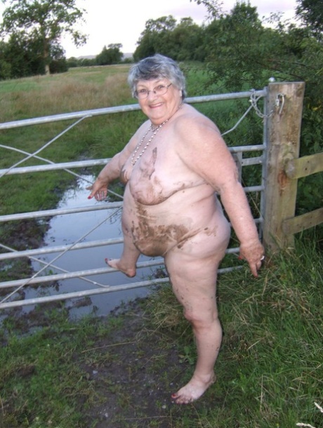 Fat nan Grandma Libby steps into a puddle before covering herself in mud