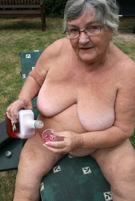 Naughty amateur granny Libby inserting a bottle in her fat pussy in the garden