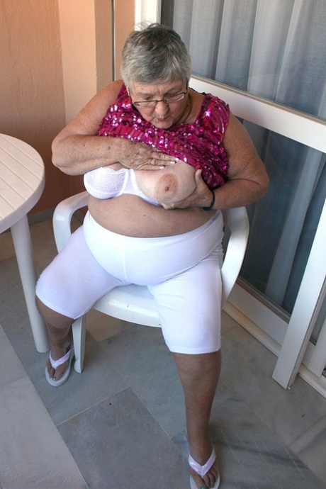 Obese grandmother GrandmaLibby parts her labia lips after disrobing on balcony