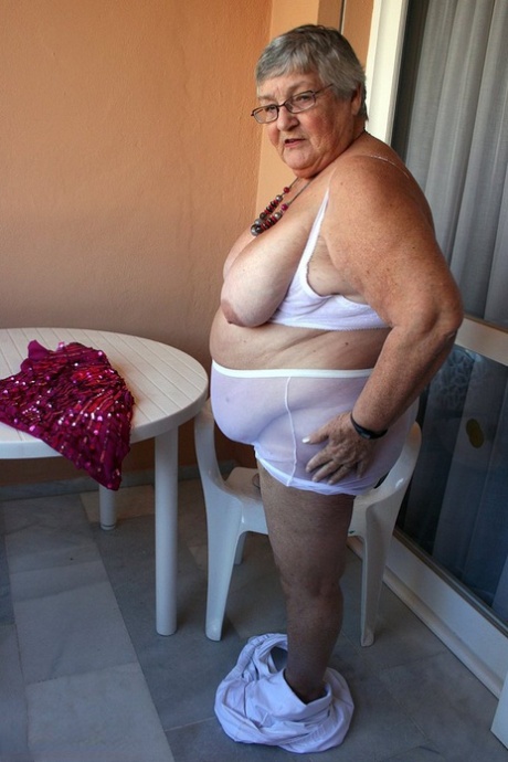 Obese grandmother GrandmaLibby parts her labia lips after disrobing on balcony