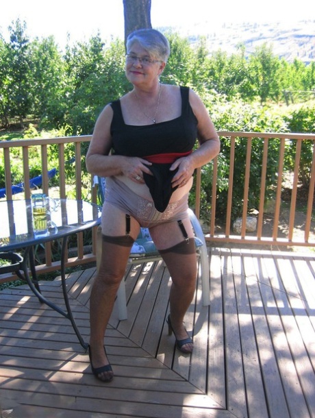 Amateur grandmother Girdle Goddess smokes before getting naked in nylons