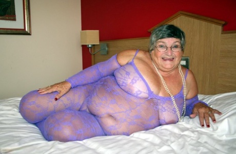 British fatty Grandma Libby masturbates on a bed in a crotchless bodystocking
