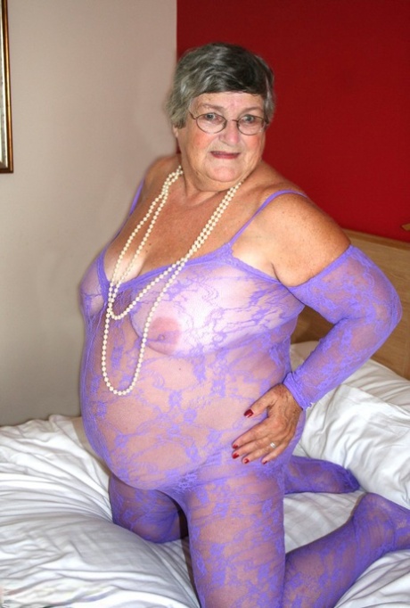 British fatty Grandma Libby masturbates on a bed in a crotchless bodystocking