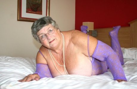 British fatty Grandma Libby masturbates on a bed in a crotchless bodystocking