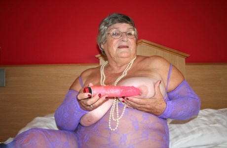 British fatty Grandma Libby masturbates on a bed in a crotchless bodystocking