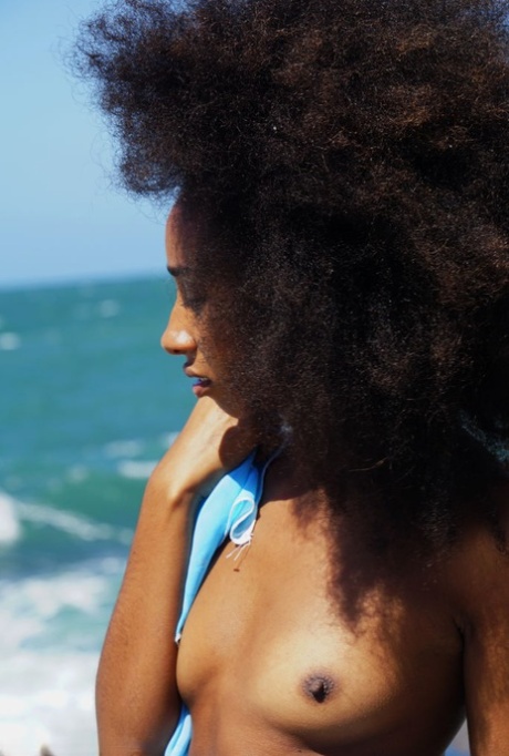 Black girl with a big fro Isadora shows her bald slit and hot ass by the ocean