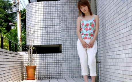 Young Japanese girl Akari shyly puts her hairy muff on display