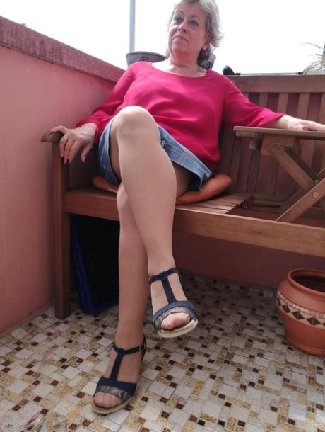Horny oma spreads her upskirt pussy after pulling down her hose on patio