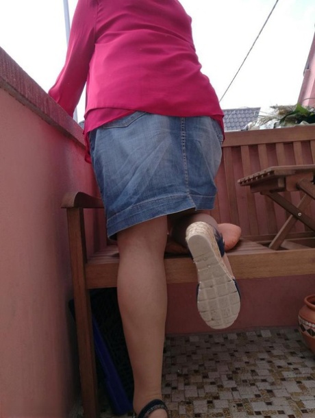Horny oma spreads her upskirt pussy after pulling down her hose on patio