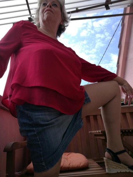 Horny oma spreads her upskirt pussy after pulling down her hose on patio
