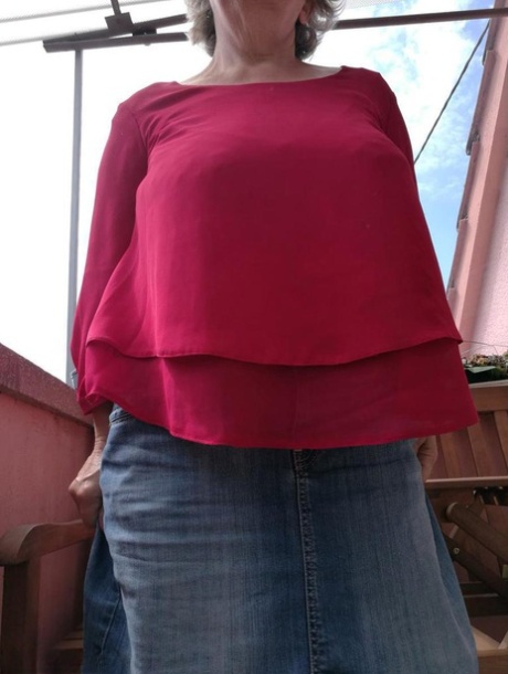 Horny oma spreads her upskirt pussy after pulling down her hose on patio