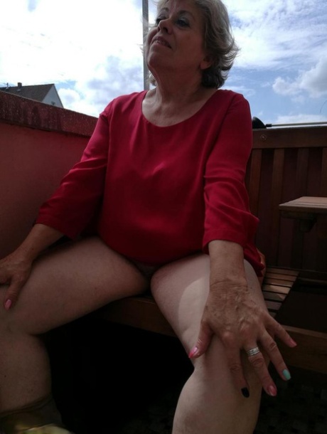 Horny oma spreads her upskirt pussy after pulling down her hose on patio