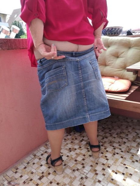 Horny oma spreads her upskirt pussy after pulling down her hose on patio