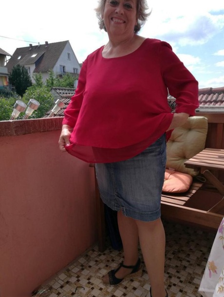 Horny oma spreads her upskirt pussy after pulling down her hose on patio