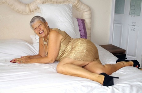 Hot granny Savana showcases her shaved pussy after a naughty striptease