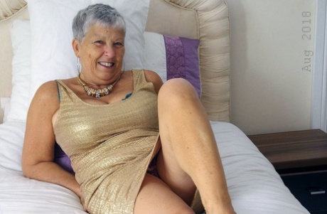 Hot granny Savana showcases her shaved pussy after a naughty striptease