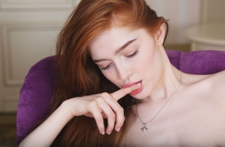 Fair skinned redhead Jia Lissa pets her trimmed pussy while totally naked