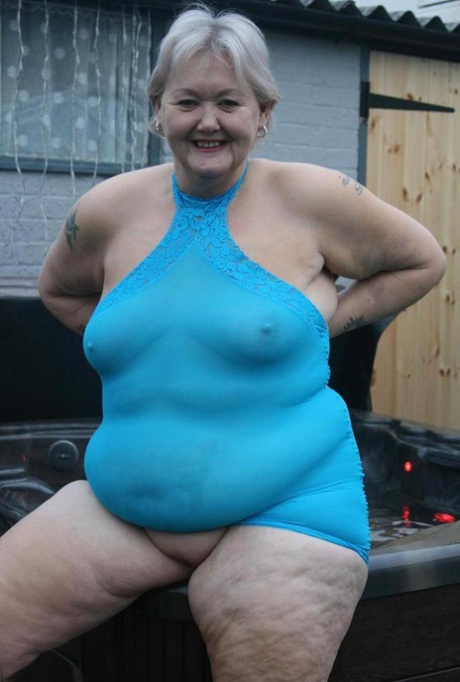 Fat granny hikes up see thru dress to expose her vagina in black pumps