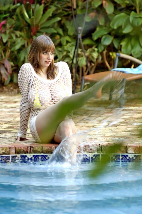 Busty Christy Marks shedding string bikini to wet huge big tits in the pool