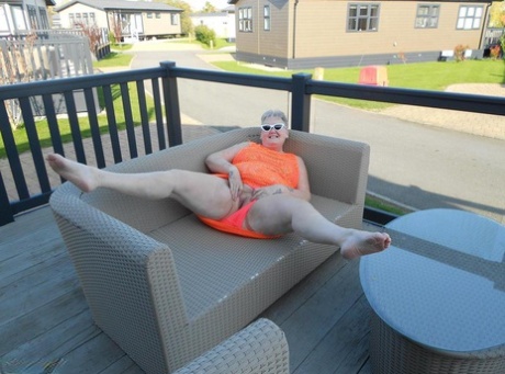Fat nan bares her boobs while in a patio hot tub before getting naked on a bed