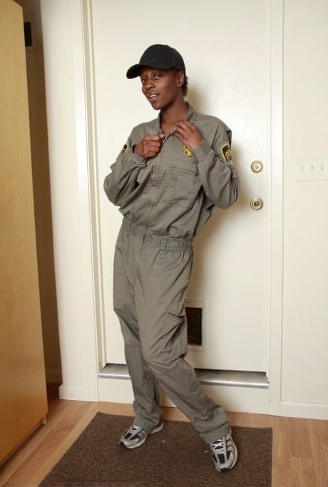 30 plus black woman Entice disrobes to sock and runners in a ball cap