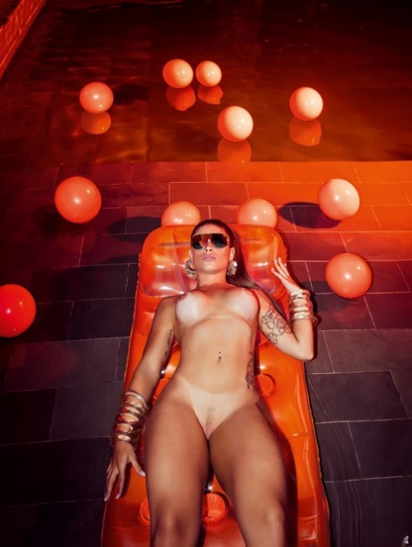 Tatted girl Rita Mattos shows her hot ass while posing for a centerfold shoot
