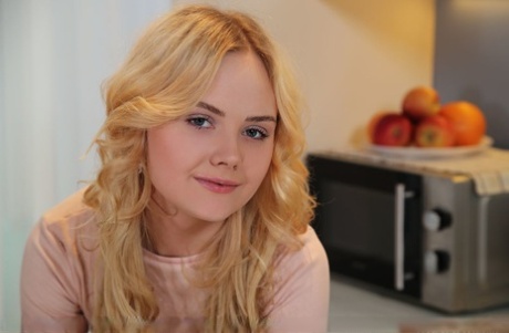 Young looking blond Isabella Star confidently removes her clothes to pose nude