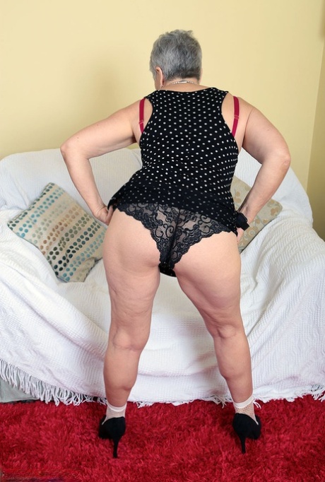 Sexy granny Savana flashes upskirt underwear before unleashing her large boobs